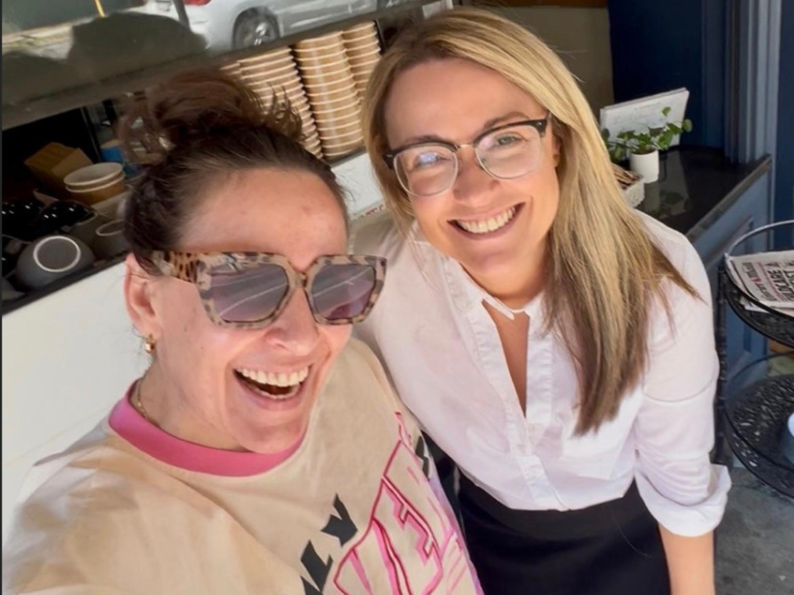Two Between Counsel members laughing together over coffee